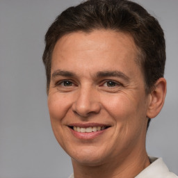 Joyful white adult male with short  brown hair and brown eyes