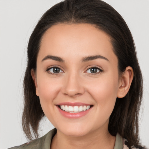 Joyful white young-adult female with medium  brown hair and brown eyes