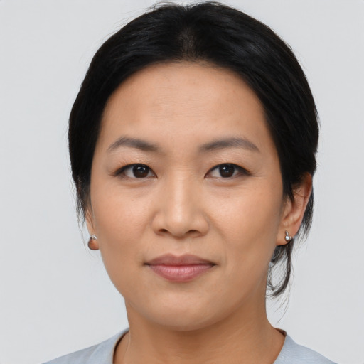 Joyful asian young-adult female with medium  black hair and brown eyes