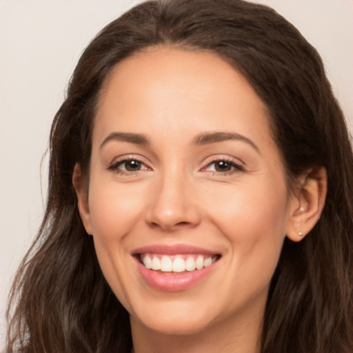 Joyful white young-adult female with long  brown hair and brown eyes