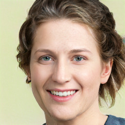 Joyful white young-adult female with medium  brown hair and green eyes