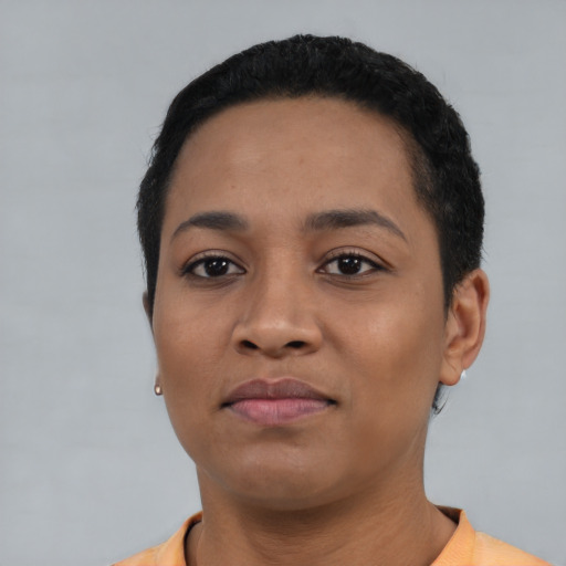 Joyful black young-adult female with short  black hair and brown eyes