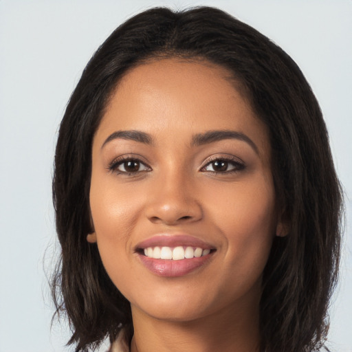 Joyful latino young-adult female with long  black hair and brown eyes