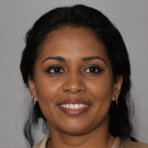 Joyful black young-adult female with medium  black hair and brown eyes