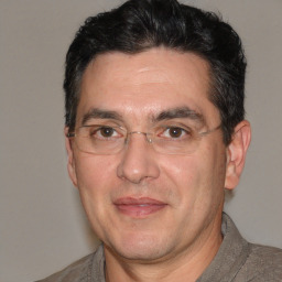 Joyful white adult male with short  black hair and brown eyes