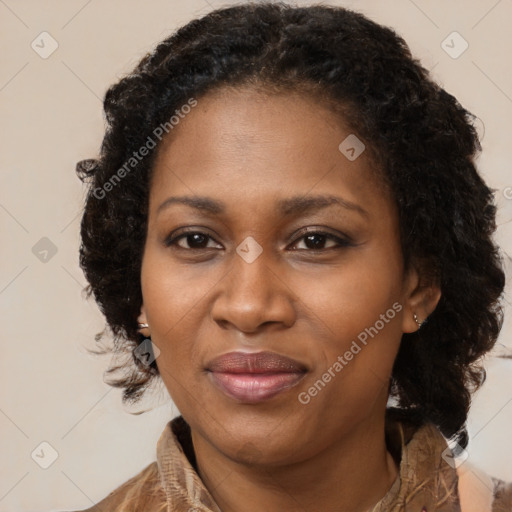 Joyful black adult female with medium  brown hair and brown eyes