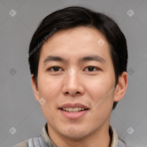 Joyful asian young-adult male with short  brown hair and brown eyes