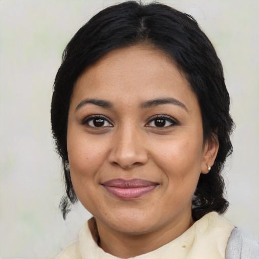 Joyful latino adult female with medium  black hair and brown eyes