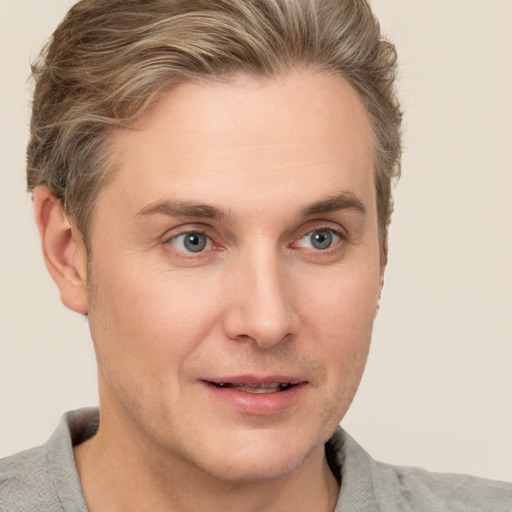 Joyful white adult male with short  brown hair and grey eyes