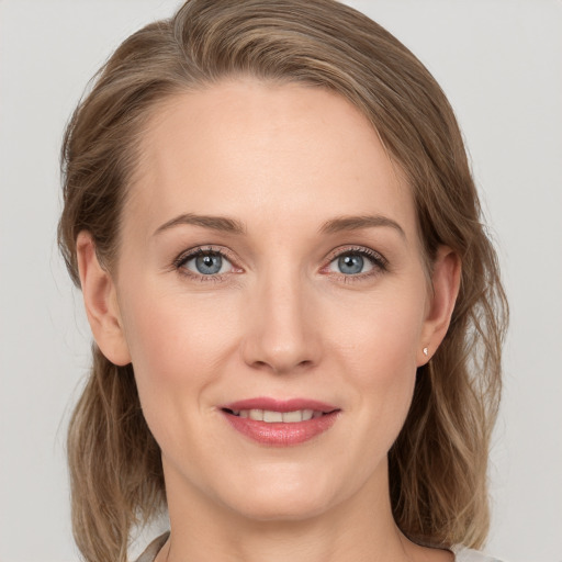 Joyful white young-adult female with medium  brown hair and blue eyes