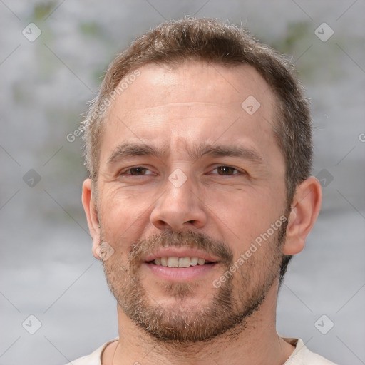 Joyful white adult male with short  brown hair and brown eyes