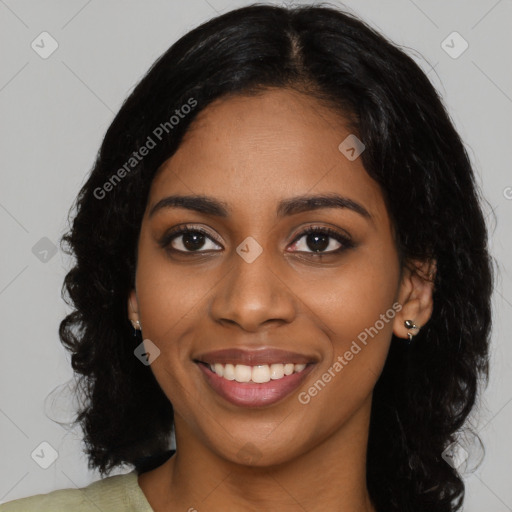 Joyful black young-adult female with long  black hair and brown eyes