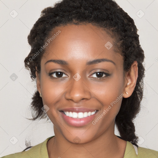 Joyful black young-adult female with long  brown hair and brown eyes