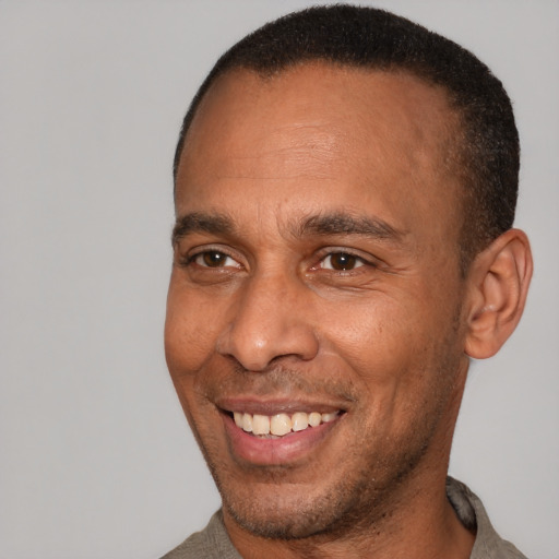 Joyful latino adult male with short  brown hair and brown eyes