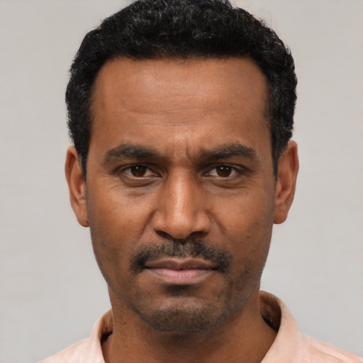 Neutral latino adult male with short  black hair and brown eyes