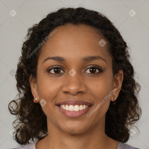 Joyful black young-adult female with medium  brown hair and brown eyes