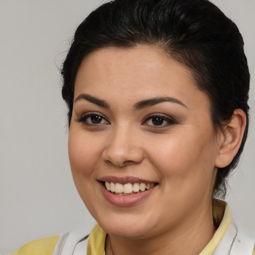 Joyful latino young-adult female with medium  brown hair and brown eyes