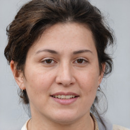 Joyful white adult female with medium  brown hair and brown eyes