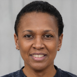 Joyful black adult female with short  brown hair and brown eyes