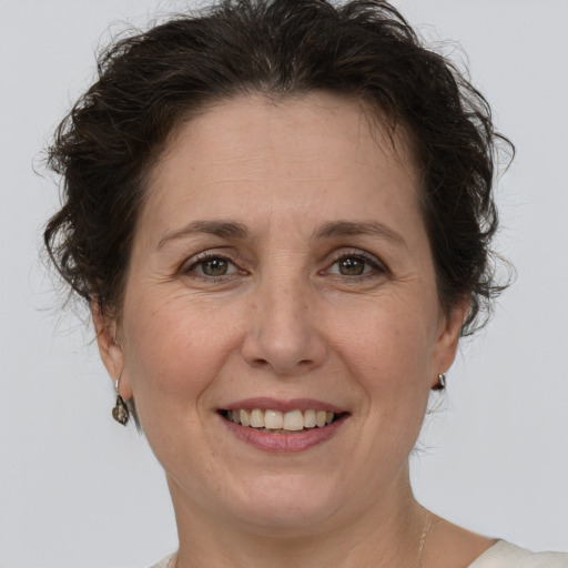 Joyful white adult female with short  brown hair and brown eyes