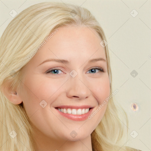 Joyful white young-adult female with long  blond hair and blue eyes