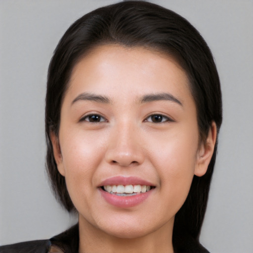 Joyful white young-adult female with medium  black hair and brown eyes