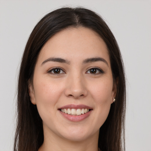 Joyful white young-adult female with long  brown hair and brown eyes