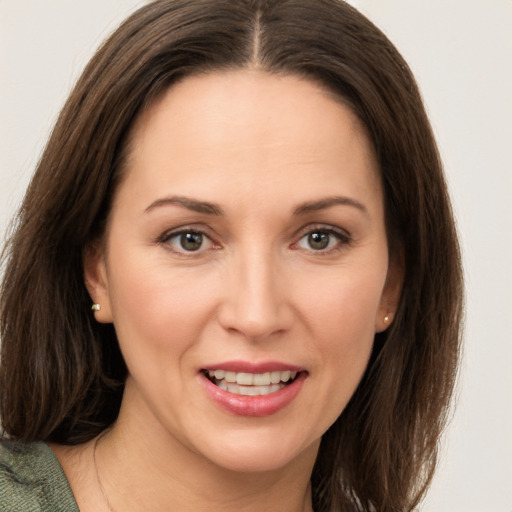 Joyful white young-adult female with medium  brown hair and grey eyes