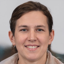 Joyful white young-adult male with medium  brown hair and brown eyes