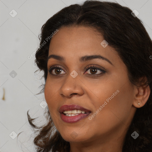 Joyful black young-adult female with long  brown hair and brown eyes