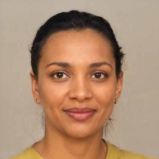 Joyful latino young-adult female with short  black hair and brown eyes