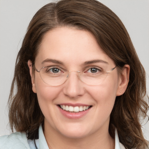 Joyful white adult female with medium  brown hair and grey eyes