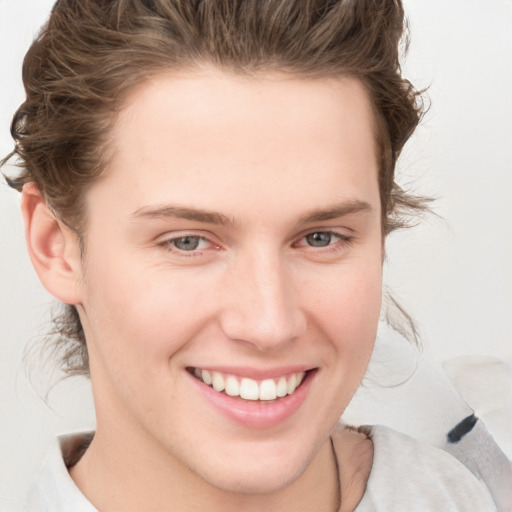 Joyful white young-adult female with medium  brown hair and blue eyes