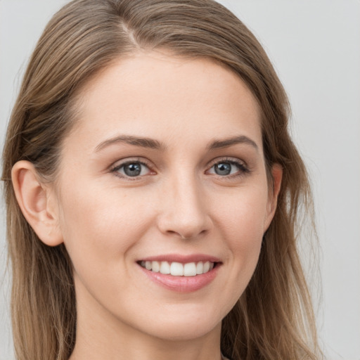 Joyful white young-adult female with long  brown hair and grey eyes