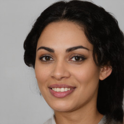 Joyful latino young-adult female with medium  black hair and brown eyes