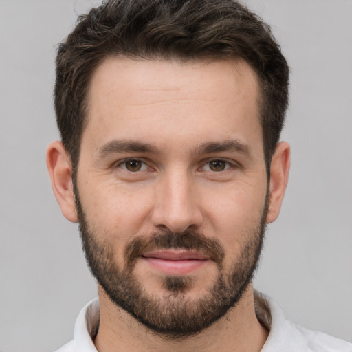 Joyful white young-adult male with short  brown hair and brown eyes