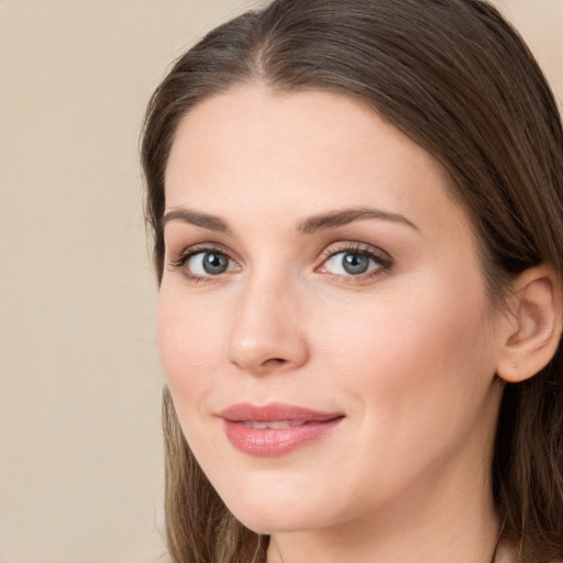 Joyful white young-adult female with long  brown hair and green eyes