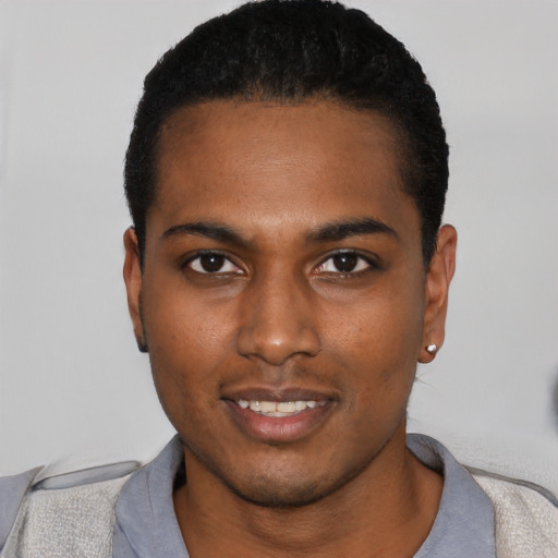 Joyful black young-adult male with short  black hair and brown eyes