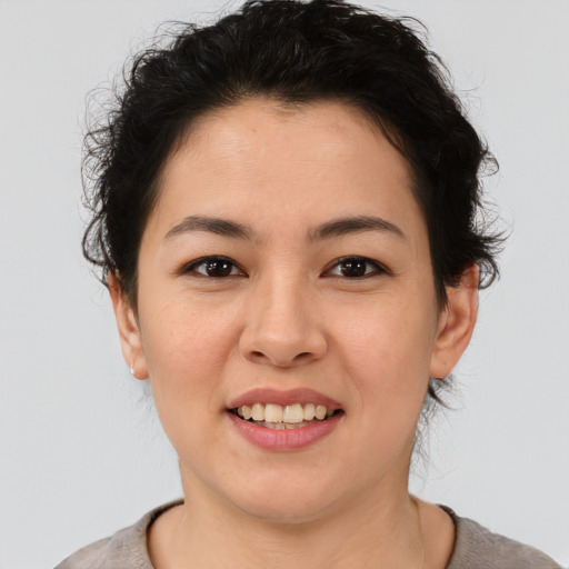 Joyful latino young-adult female with short  brown hair and brown eyes