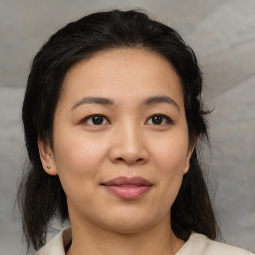 Joyful asian young-adult female with medium  brown hair and brown eyes