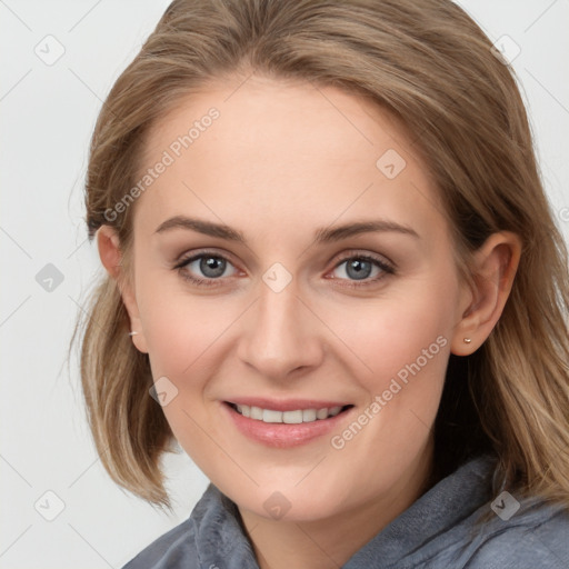 Joyful white young-adult female with medium  brown hair and blue eyes