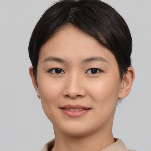 Joyful asian young-adult female with short  brown hair and brown eyes
