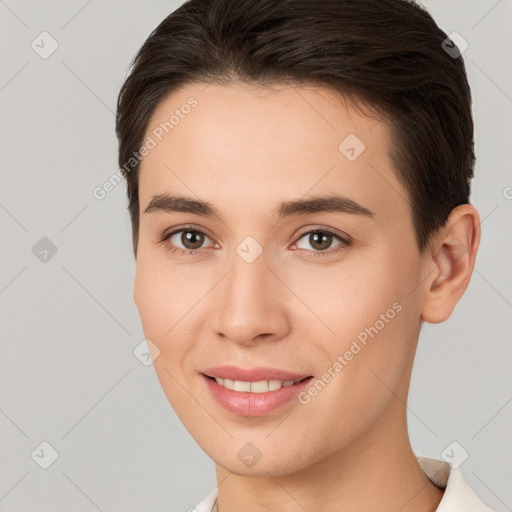 Joyful white young-adult female with short  brown hair and brown eyes