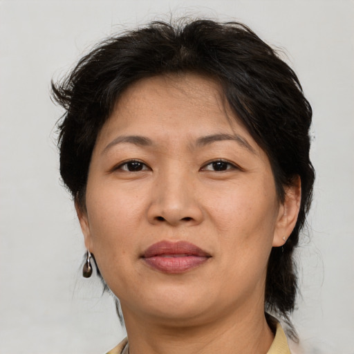 Joyful asian adult female with short  brown hair and brown eyes
