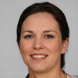 Joyful white adult female with medium  brown hair and brown eyes