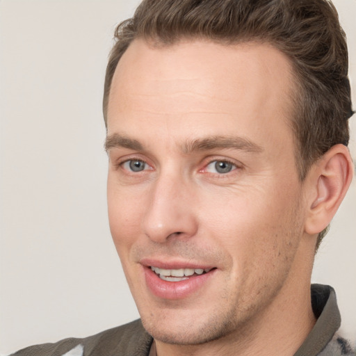 Joyful white adult male with short  brown hair and brown eyes