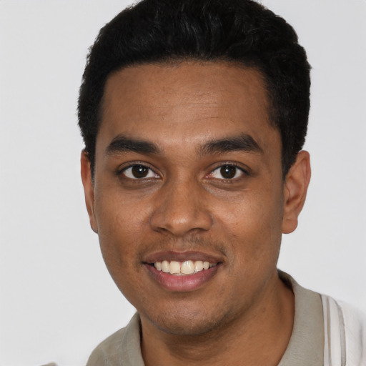 Joyful black young-adult male with short  black hair and brown eyes