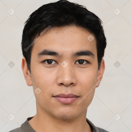 Joyful asian young-adult male with short  black hair and brown eyes