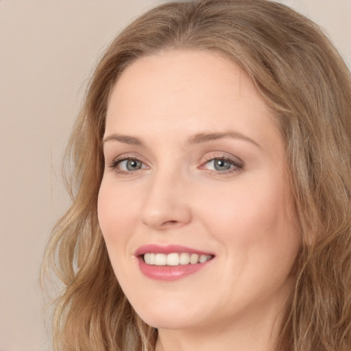 Joyful white young-adult female with long  brown hair and green eyes