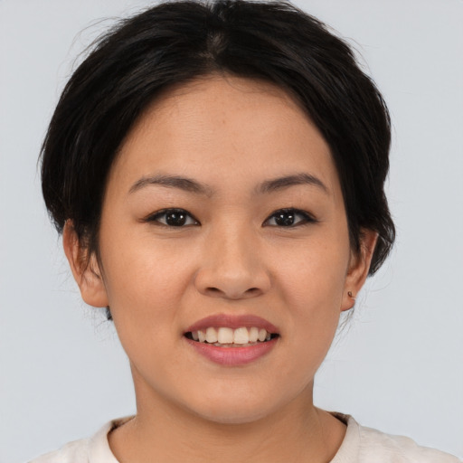Joyful asian young-adult female with medium  brown hair and brown eyes
